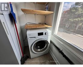 A small laundry room with a washer and dryer.