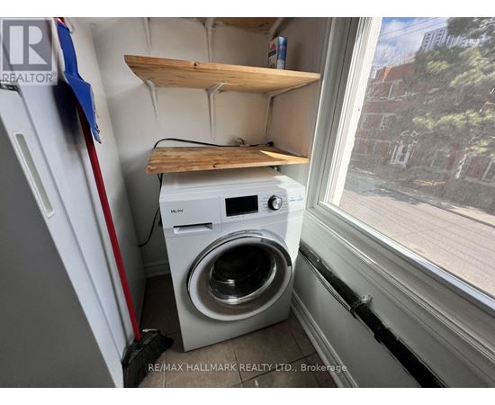 A small laundry room with a washer and dryer.