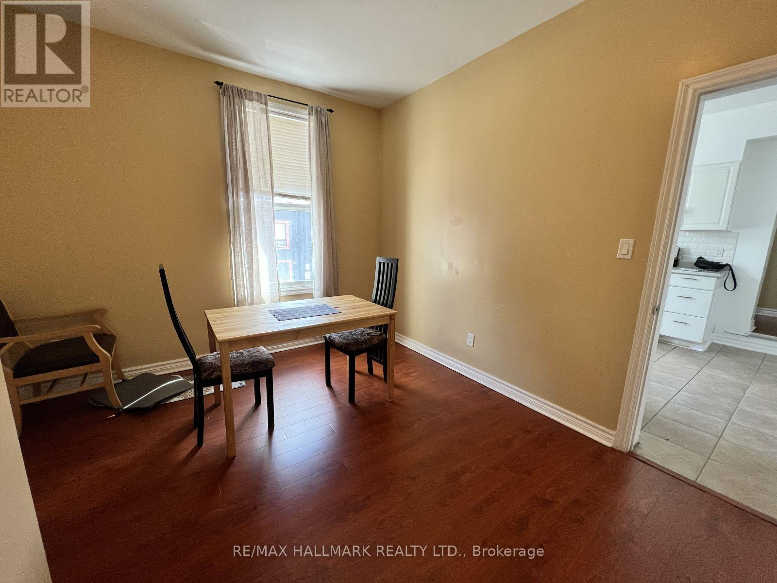 A room with a dining table and chairs in it.