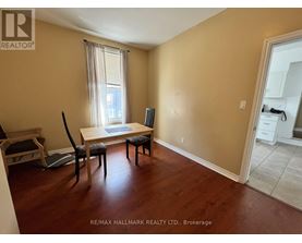 A room with a dining table and chairs in it.