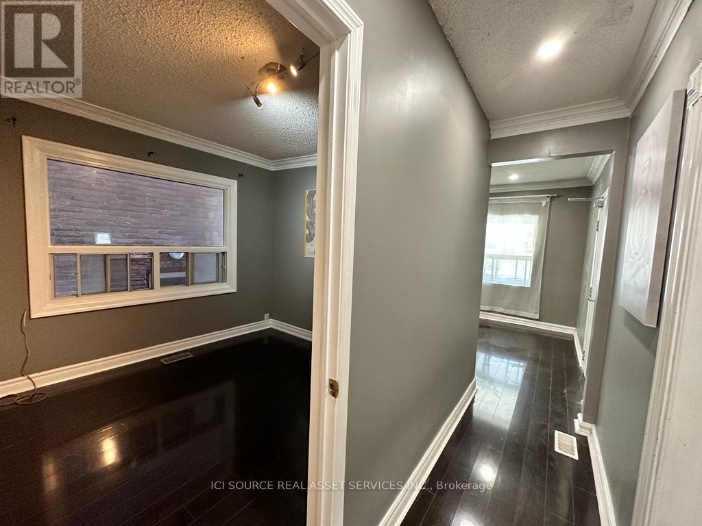A hallway with a white door and a window with blinds.