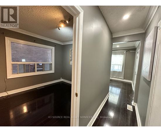 A hallway with a white door and a window with blinds.