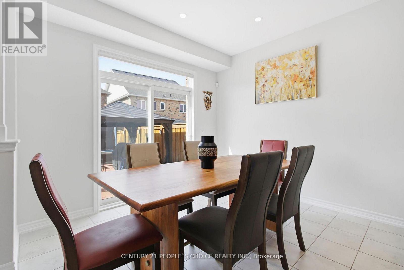 A dining room with a wooden table and chairs.