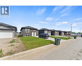 A row of houses with a REALTOR® logo in the corner.