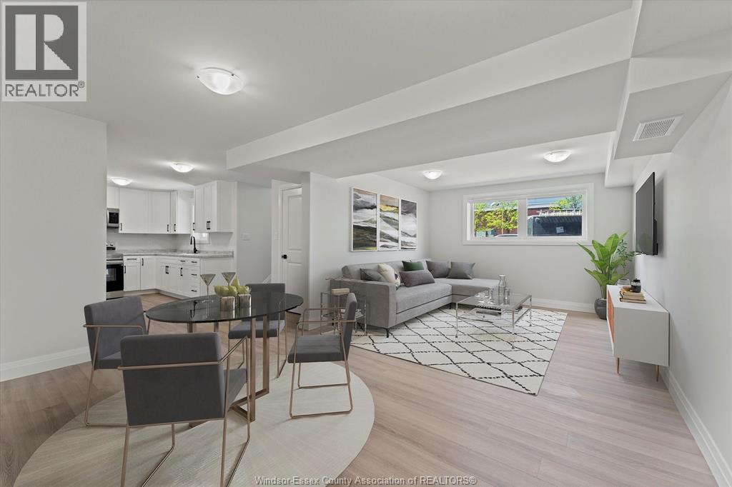 A well-lit, modern living room with a kitchen area in the background.