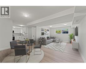 A well-lit, modern living room with a kitchen area in the background.