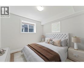 A bedroom with a large bed and a window.