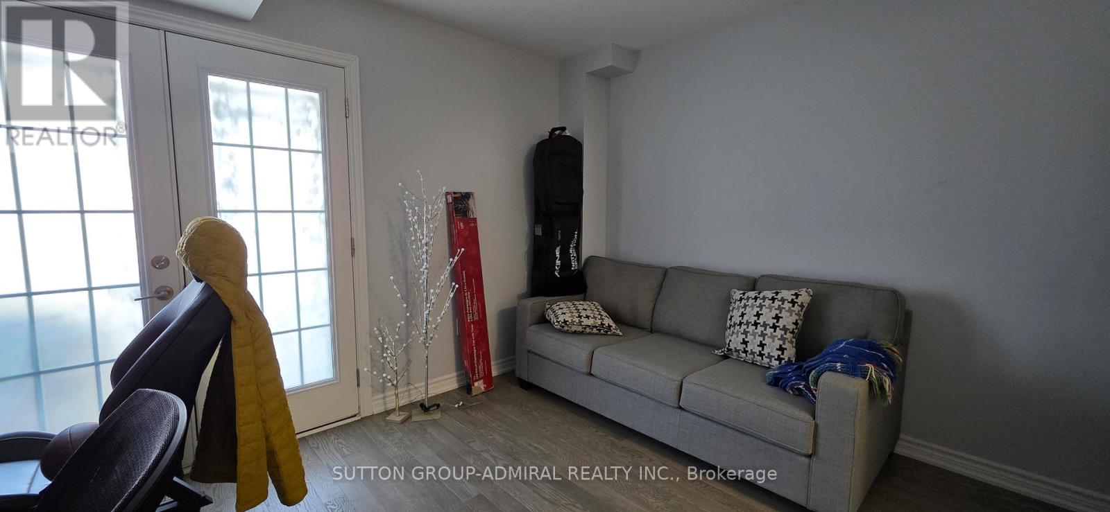 A living room with a grey couch and a chair.