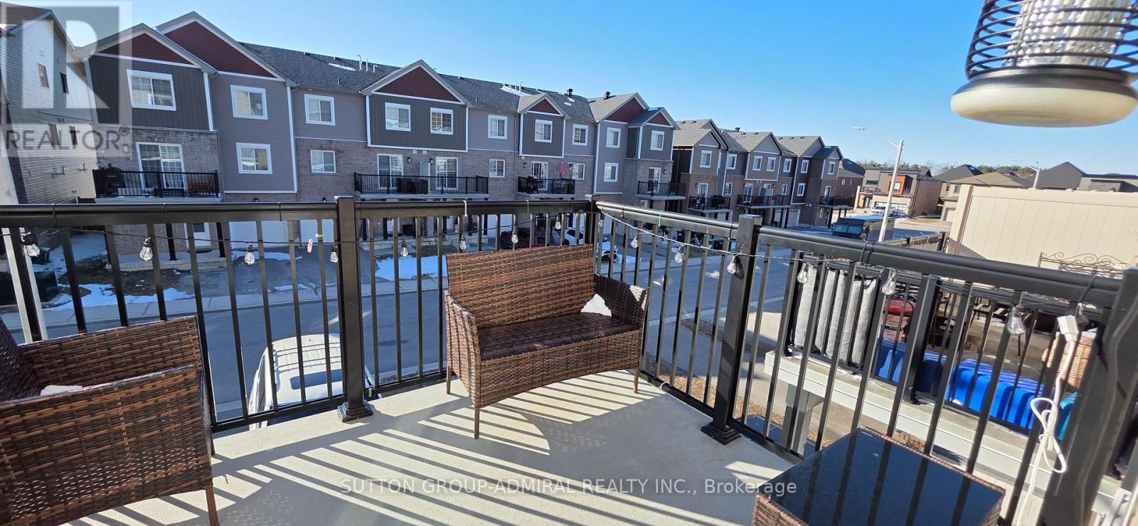 A balcony with a pool and a chair.