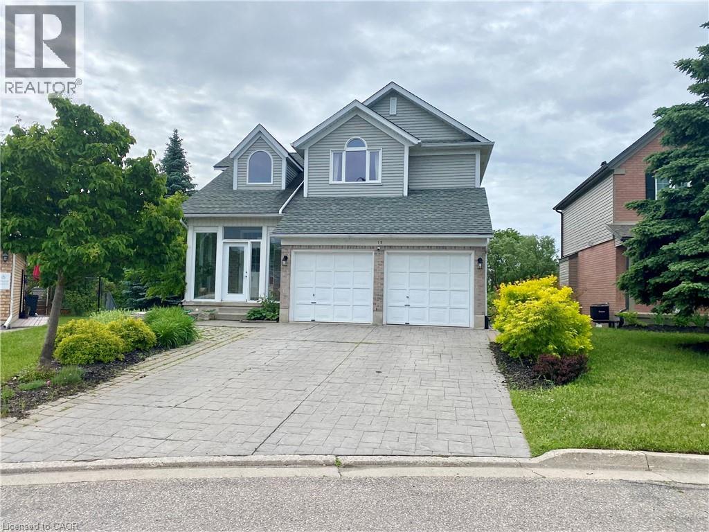 A house with a grey roof and a white garage door is for sale.