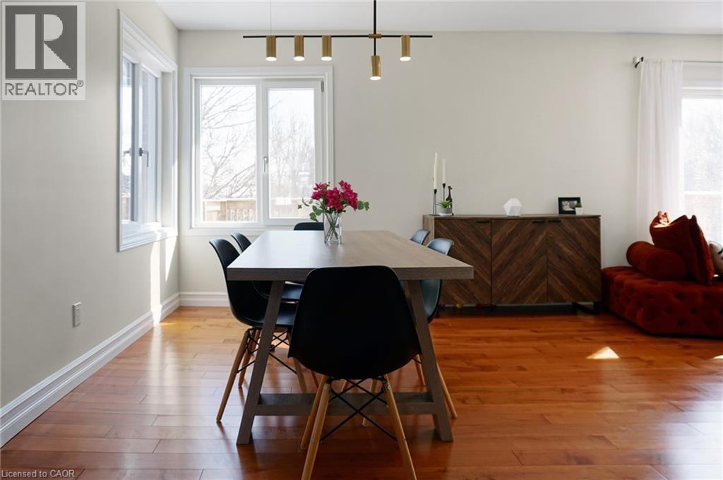 A dining room with a table and chairs.