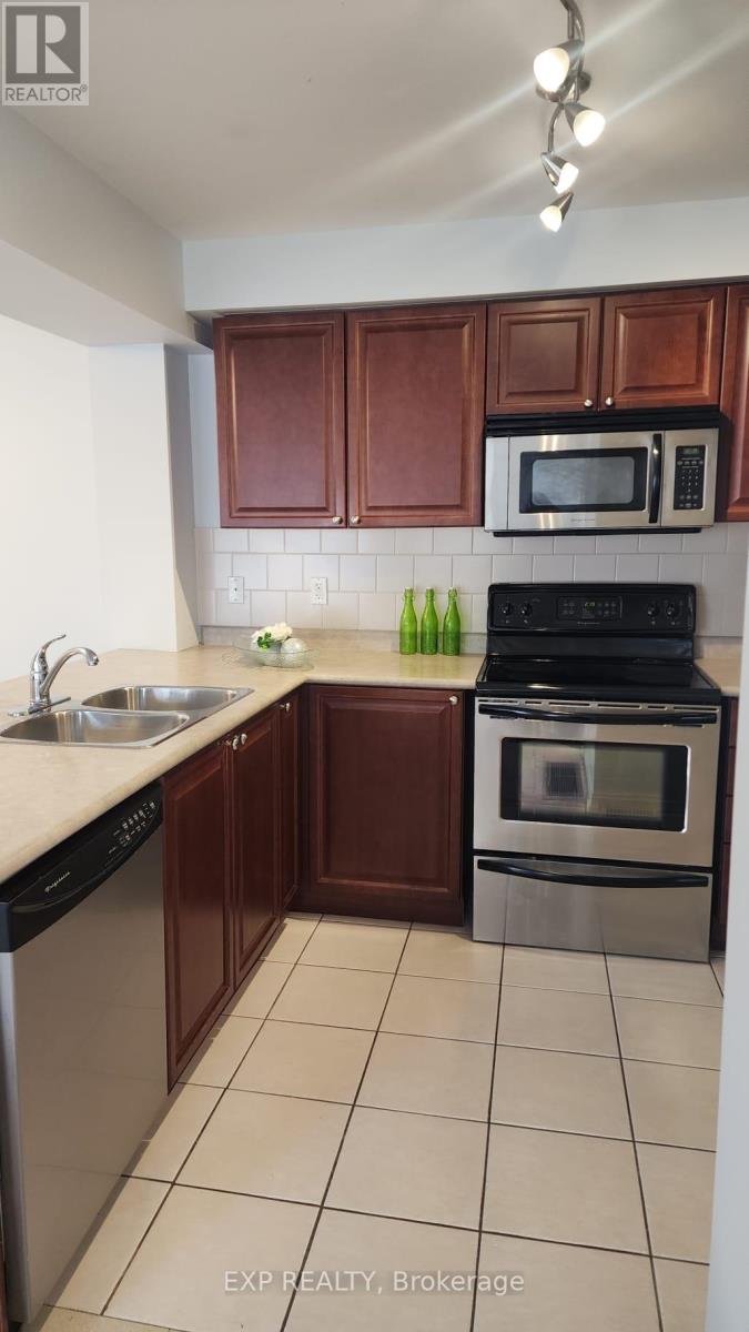 A kitchen with brown cabinets and a black stove top oven.