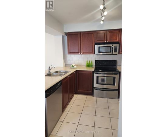 A kitchen with brown cabinets and a black stove top oven.
