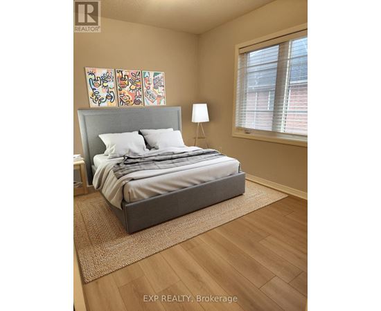A bedroom with a large bed and a painting on the wall.