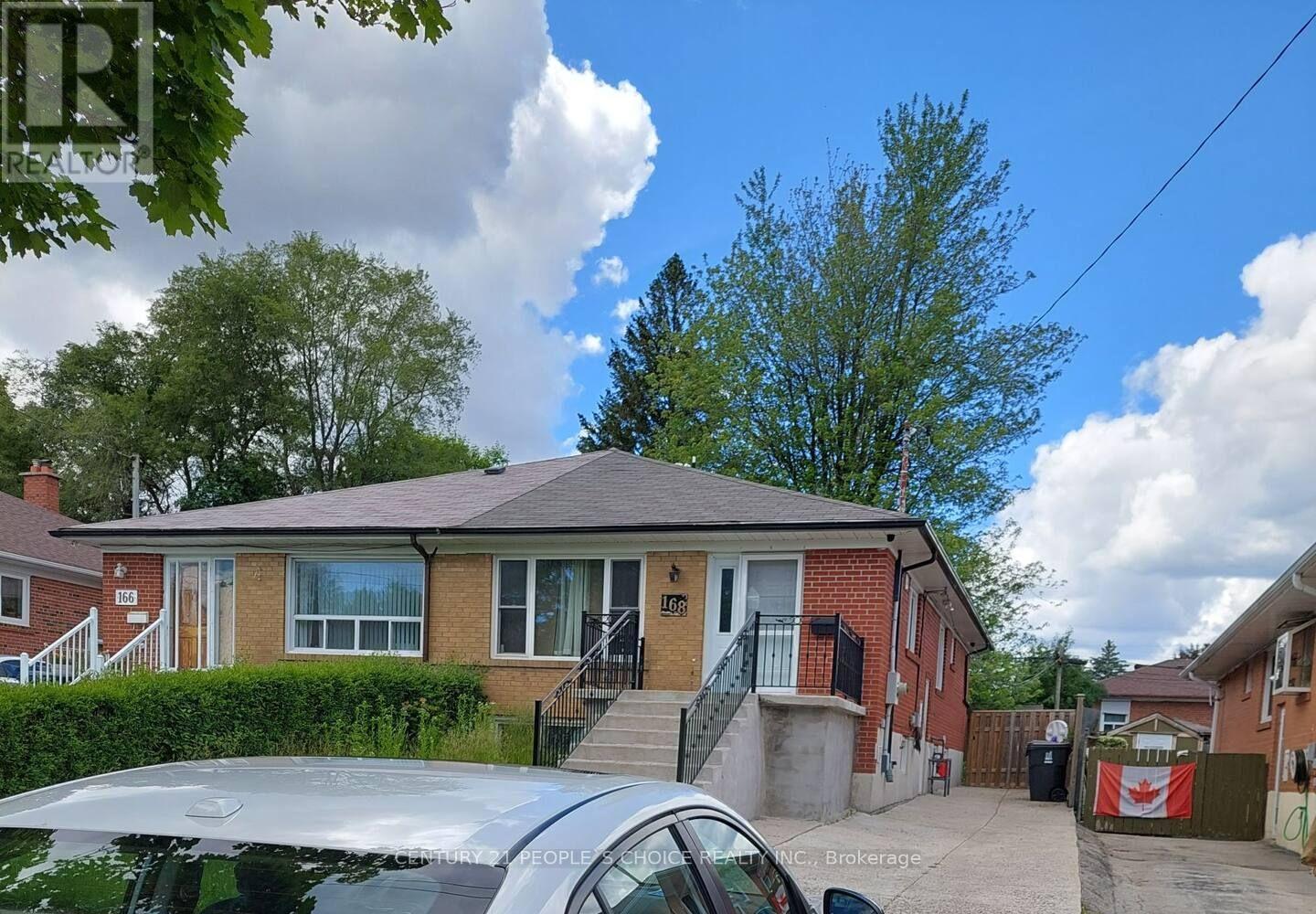 A house with a car parked in front.