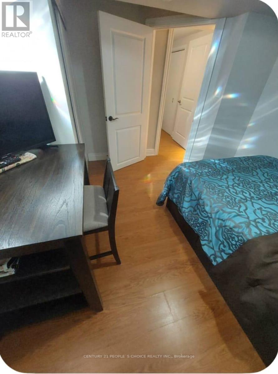 A bedroom with a bed, desk, and chair.