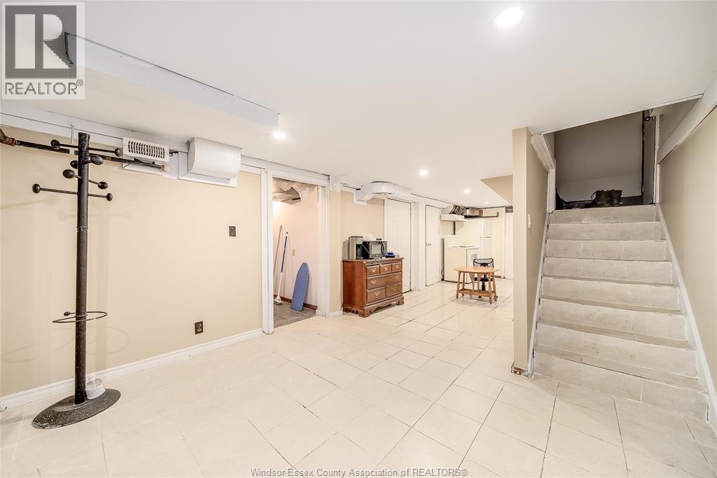 A spacious room with a staircase leading to another level.