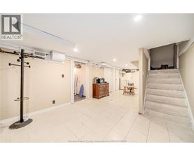 A spacious room with a staircase leading to another level.