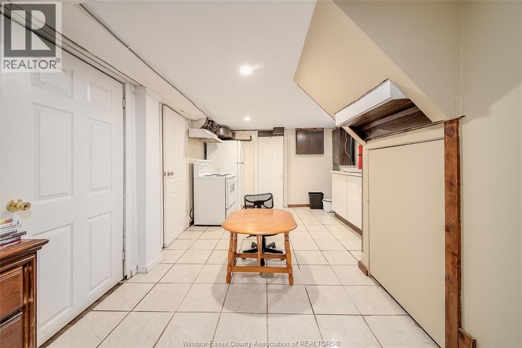 A kitchen area with a table and a refrigerator.