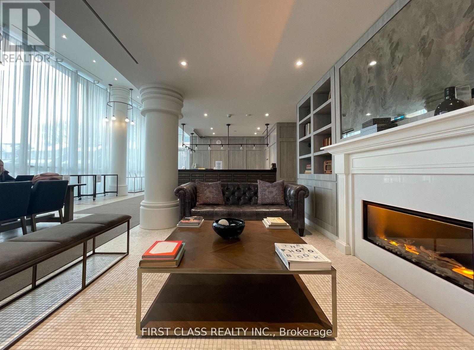 A living room with a fireplace and a coffee table.