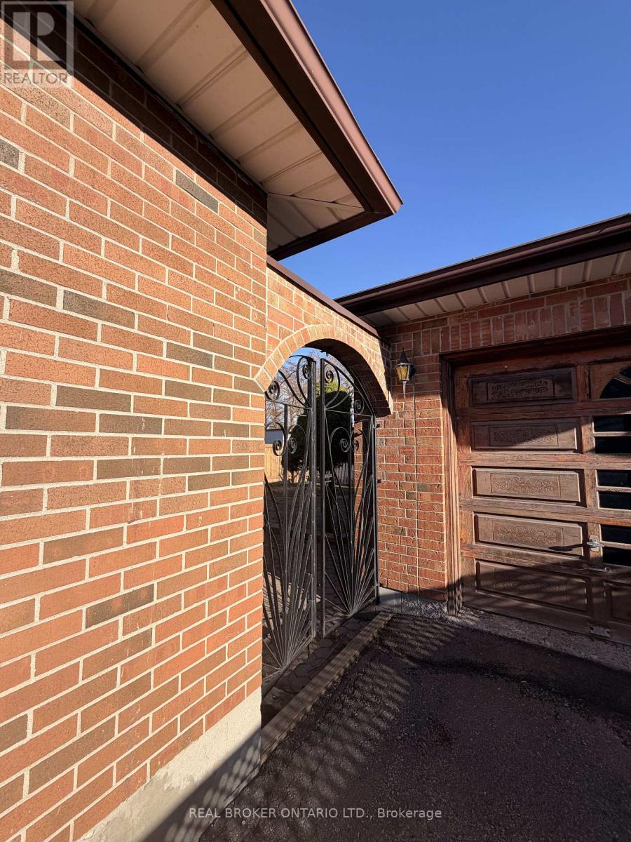 A brick wall with a gate and a window.