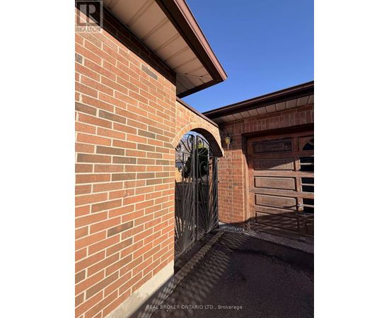 A brick wall with a gate and a window.