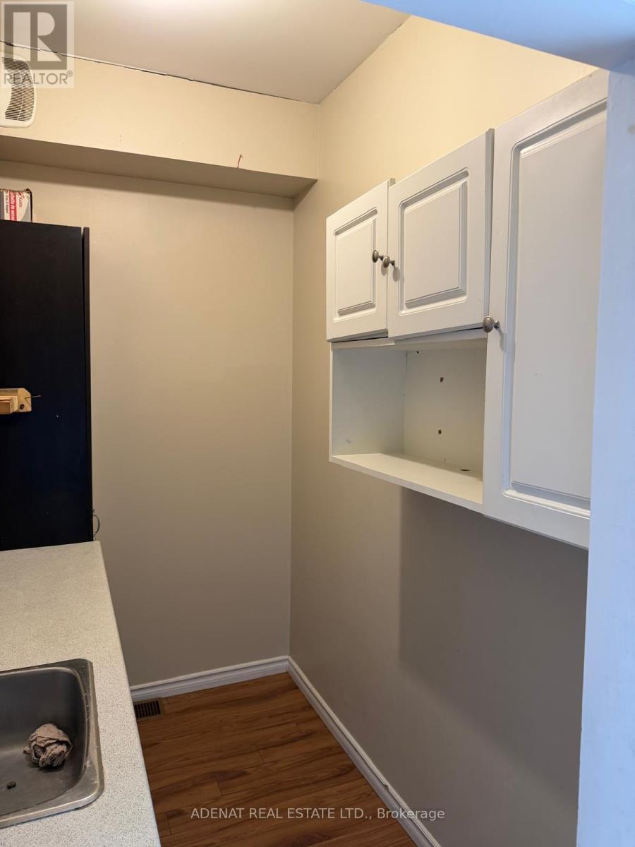 A kitchen area with a sink and cabinets.
