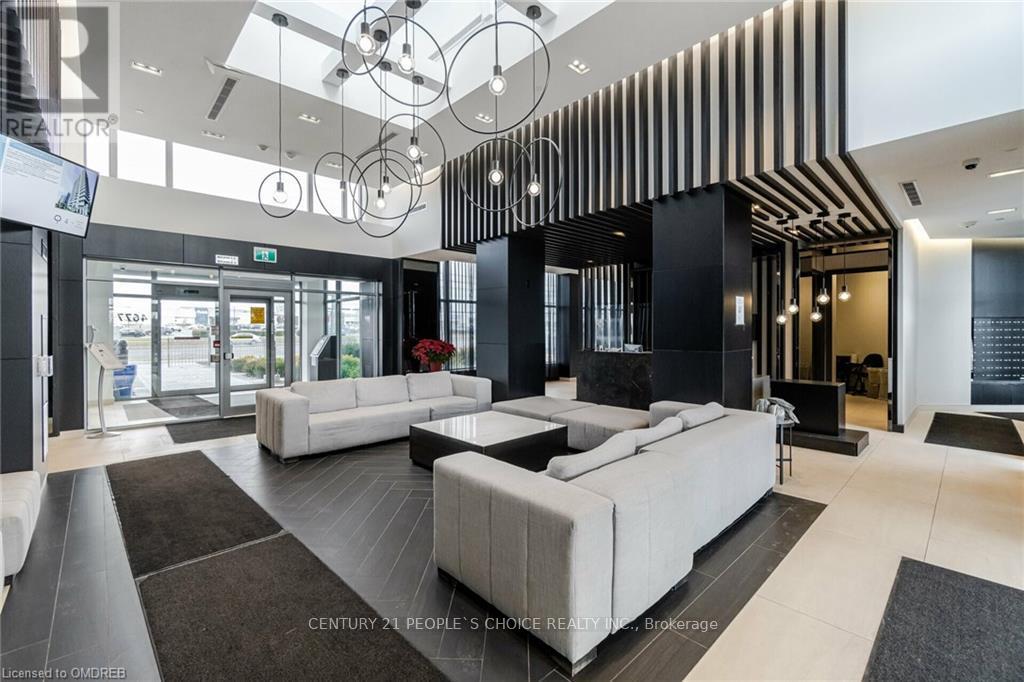 A modern living room with a white sofa set and a black and white striped wall.