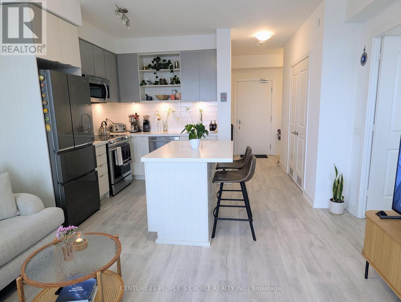 A modern kitchen with a dining table and chairs.