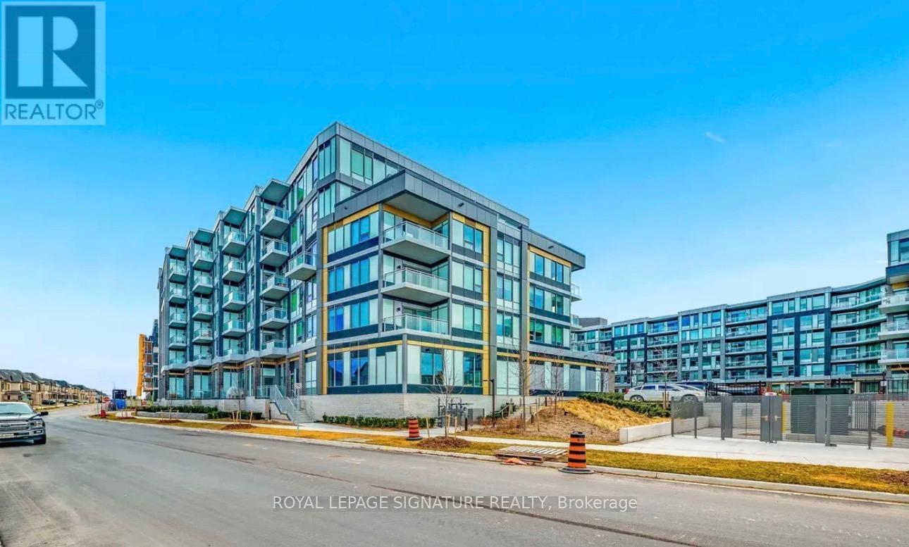 A modern multi-story building with a glass facade is under construction.