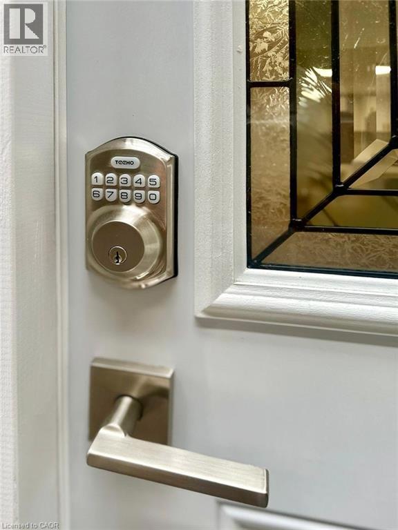 A white door with a keypad lock and a keyhole.