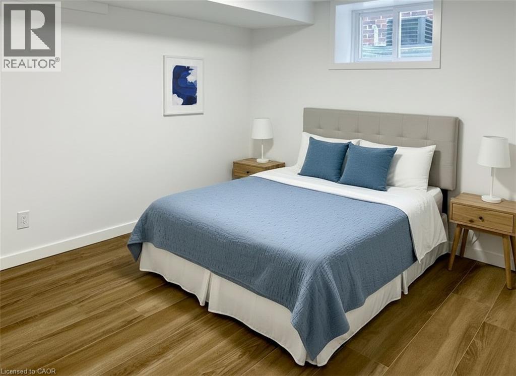 A bedroom with a bed, nightstands, and a window.