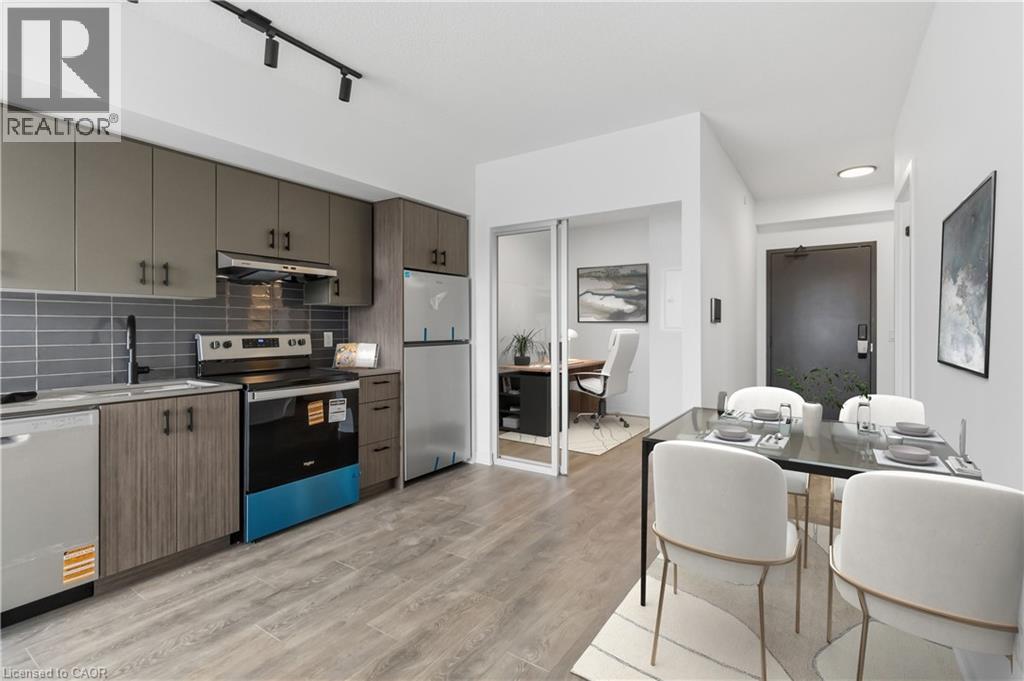A modern kitchen with a dining table set for two.