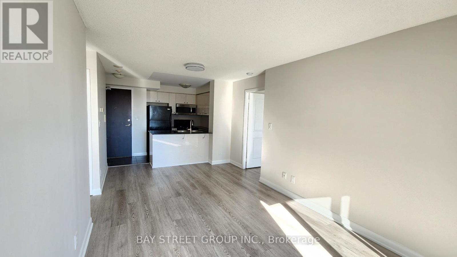 A spacious room with a sliding glass door in the middle.