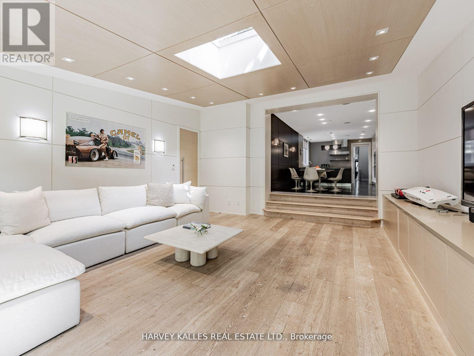 A spacious living room with a white sofa and a coffee table.