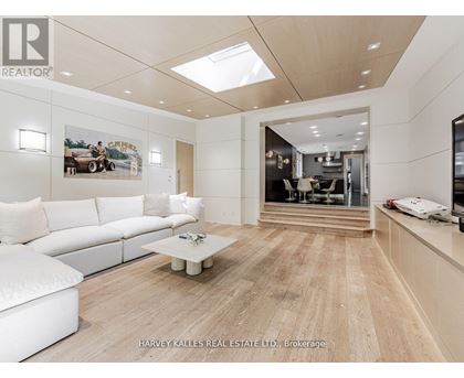 A spacious living room with a white sofa and a coffee table.