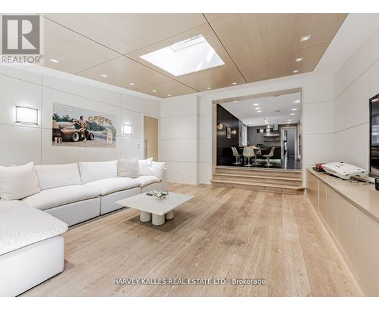 A spacious living room with a white sofa and a coffee table.