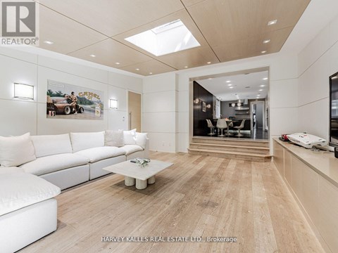 A spacious living room with a white sofa and a coffee table.