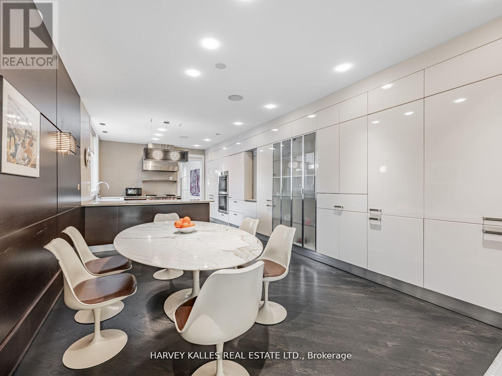 A modern kitchen with a dining table and chairs.