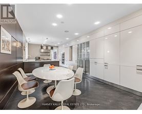 A modern kitchen with a dining table and chairs.