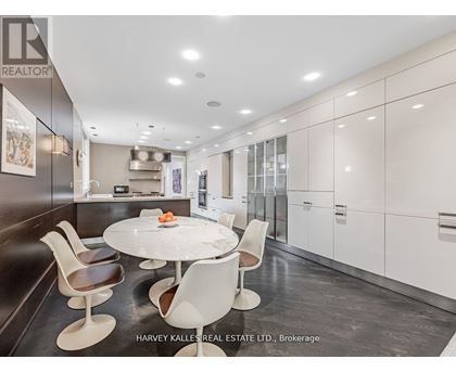 A modern kitchen with a dining table and chairs.