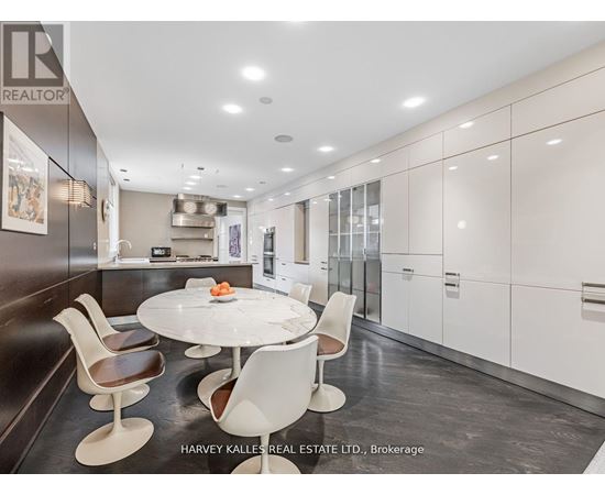 A modern kitchen with a dining table and chairs.