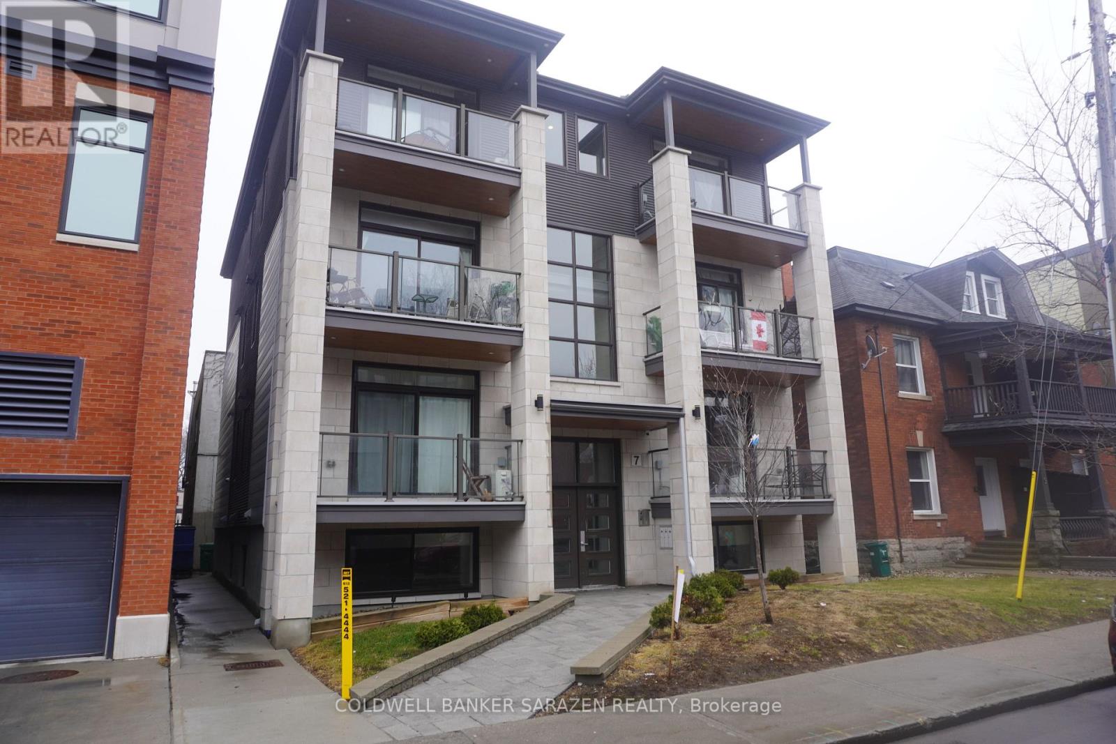 A building with a balcony and a door is shown.
