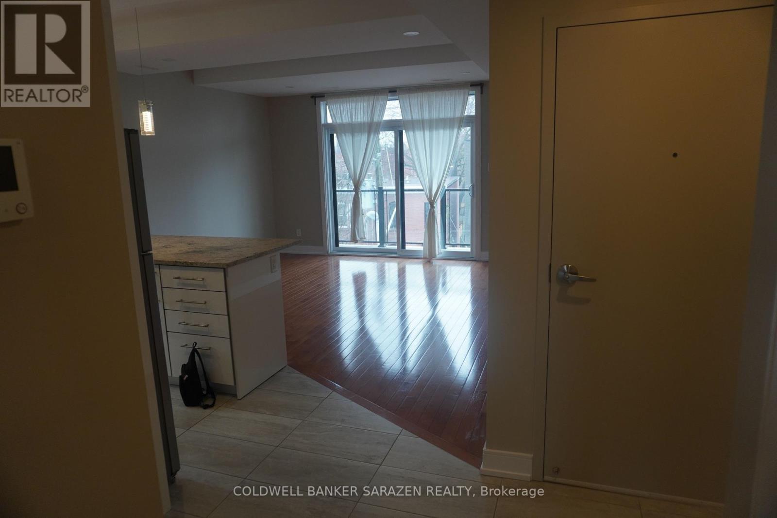 A brokerage office with a desk and a window with curtains.