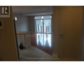 A brokerage office with a desk and a window with curtains.