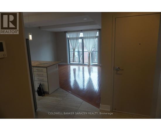 A brokerage office with a desk and a window with curtains.