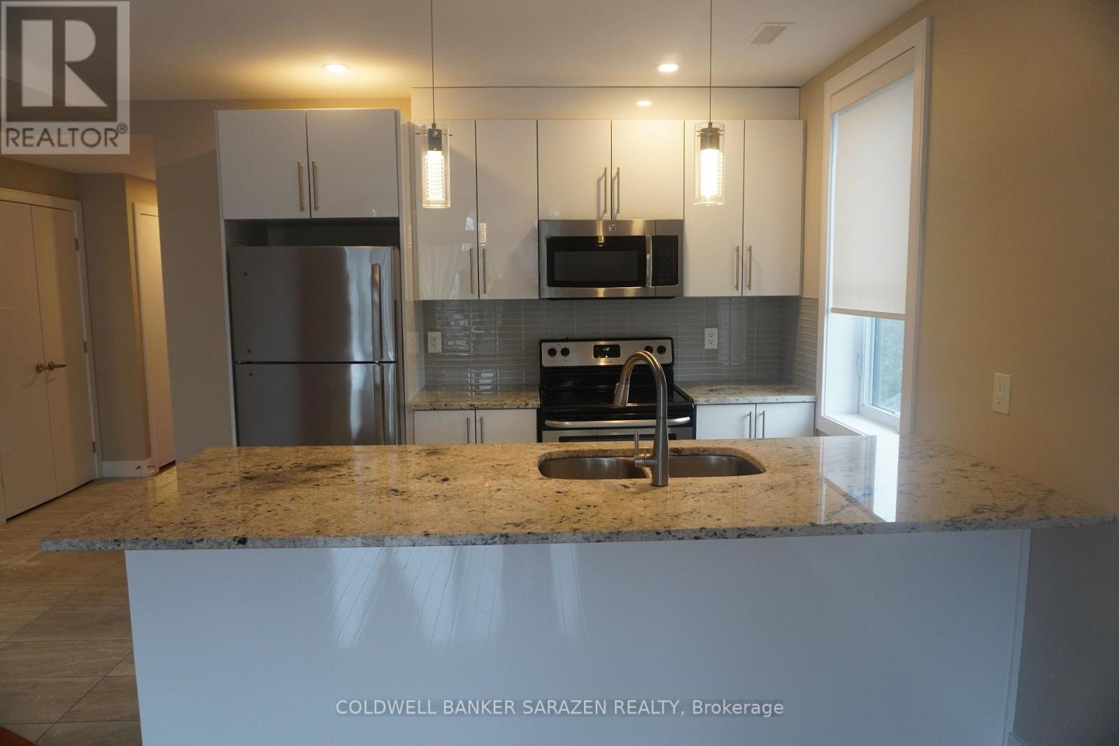 A kitchen with granite countertops and stainless steel appliances.