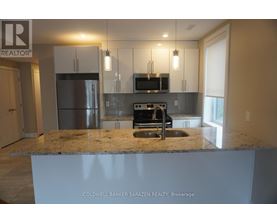 A kitchen with granite countertops and stainless steel appliances.