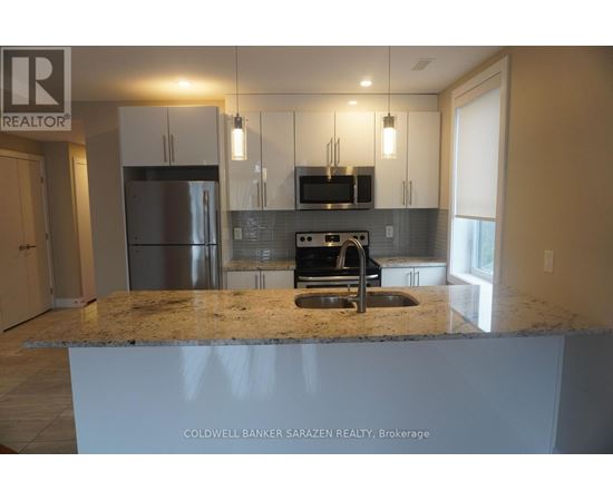 A kitchen with granite countertops and stainless steel appliances.