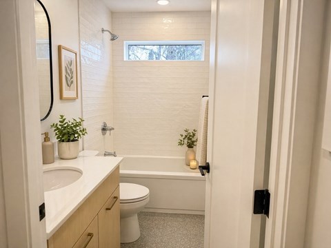 A bathroom with a white toilet, sink, and bathtub.